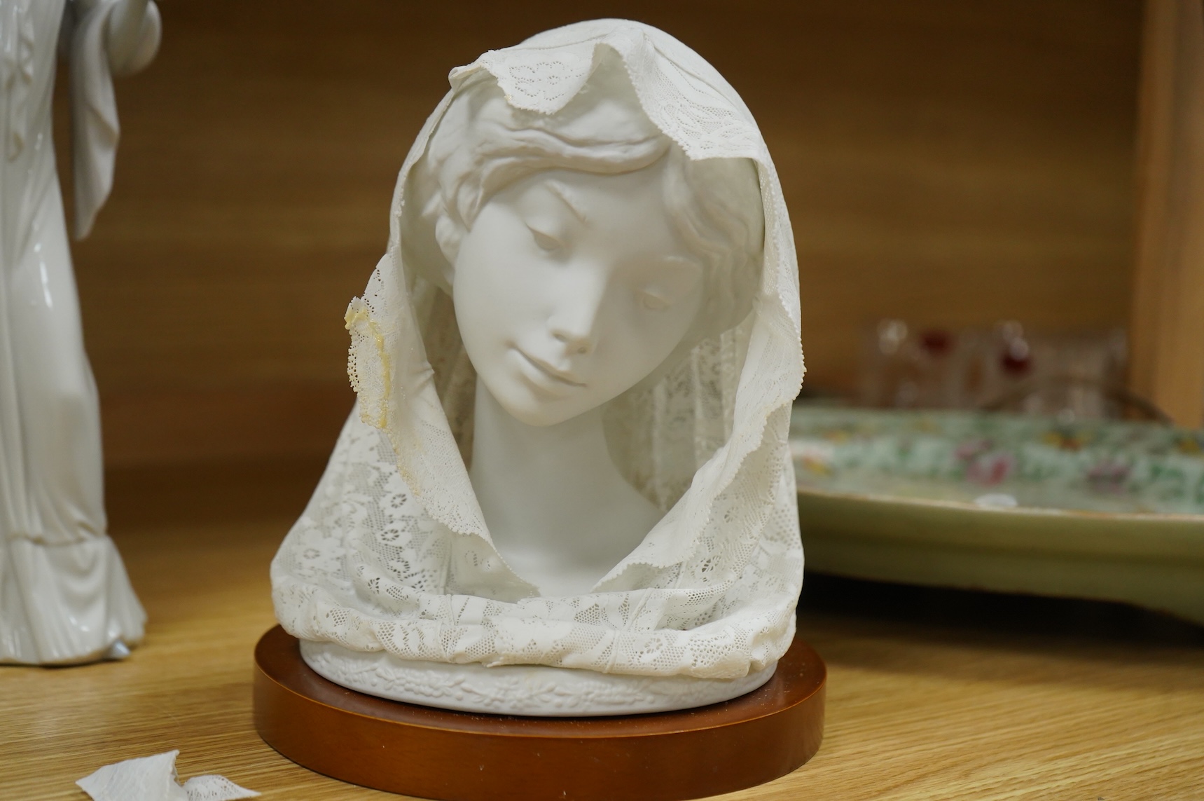 A group of Lladro figures: Bust of a lady in a lace veil, Girl with a basket, Lady holding gloves and a male reaper, 43cm high - 4 items, some boxed.